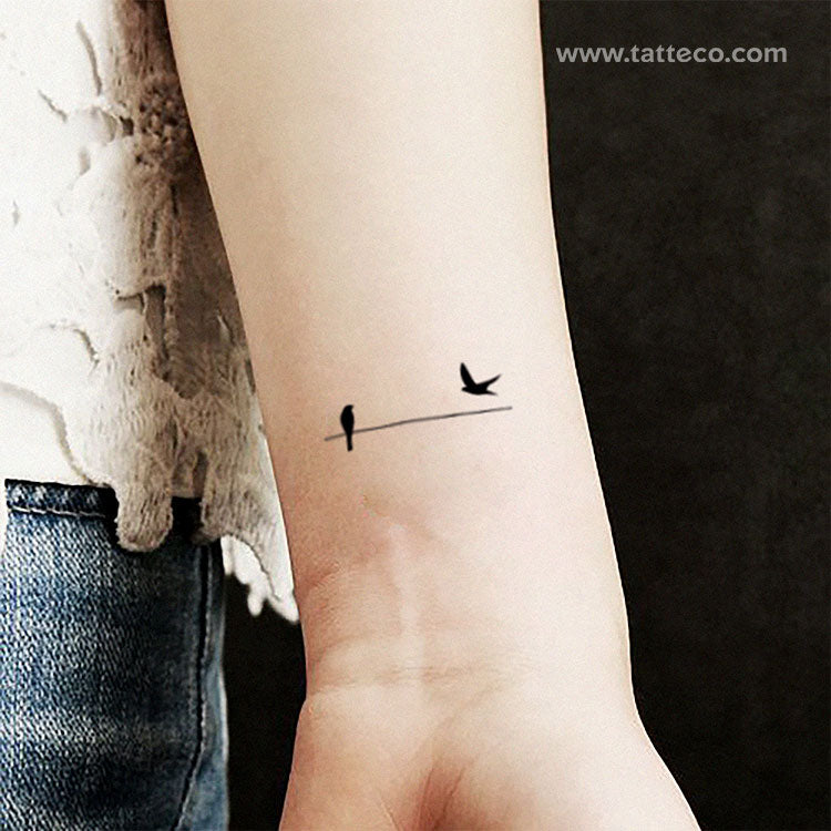 small bird on branch tattoo