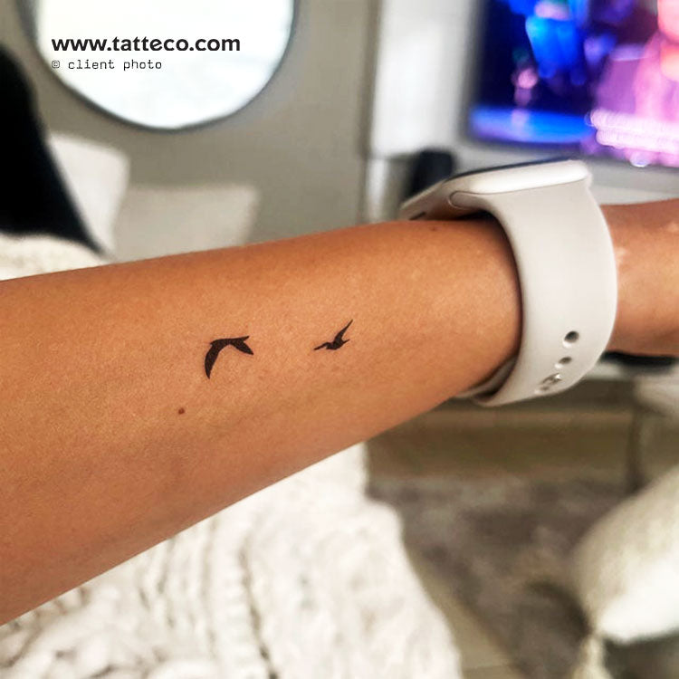 simple bird tattoo on wrist