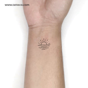 Hand poked sunset tattoo on the inner forearm